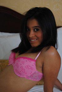 pretty student college girl smiling at camera wearing pink bra covering her nice firm boobs